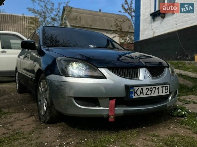 Синий Мицубиси Лансер, объемом двигателя 1.58 л и пробегом 300 тыс. км за 3300 $, фото 1 на Automoto.ua