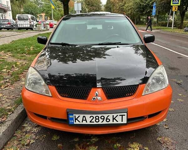Оранжевый Мицубиси Лансер, объемом двигателя 1.59 л и пробегом 325 тыс. км за 4300 $, фото 1 на Automoto.ua
