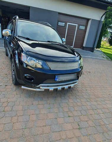 Черный Мицубиси Аутлендер ХЛ, объемом двигателя 2.4 л и пробегом 146 тыс. км за 10500 $, фото 1 на Automoto.ua