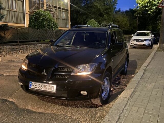 Черный Мицубиси Аутлендер, объемом двигателя 2.4 л и пробегом 312 тыс. км за 6500 $, фото 1 на Automoto.ua