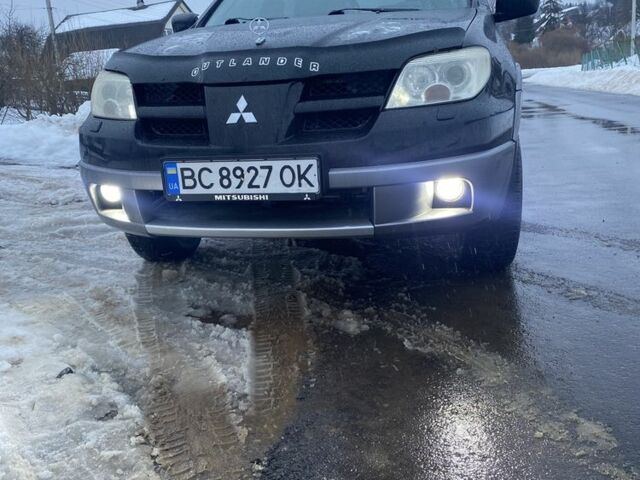 Черный Мицубиси Аутлендер, объемом двигателя 2.4 л и пробегом 226 тыс. км за 4500 $, фото 1 на Automoto.ua