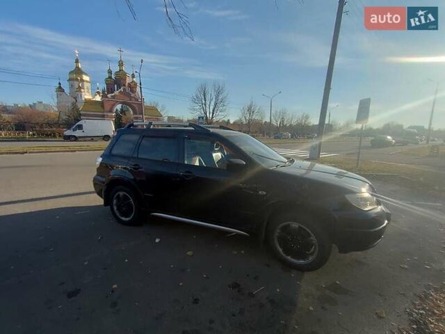 Черный Мицубиси Аутлендер, объемом двигателя 2.4 л и пробегом 182 тыс. км за 8500 $, фото 1 на Automoto.ua