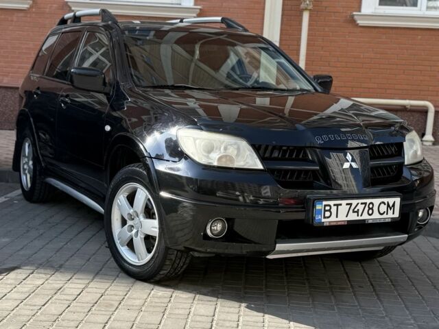 Черный Мицубиси Аутлендер, объемом двигателя 2.4 л и пробегом 192 тыс. км за 6500 $, фото 1 на Automoto.ua