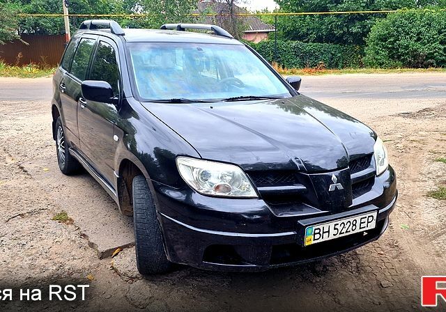 Черный Мицубиси Аутлендер, объемом двигателя 2 л и пробегом 194 тыс. км за 4200 $, фото 1 на Automoto.ua