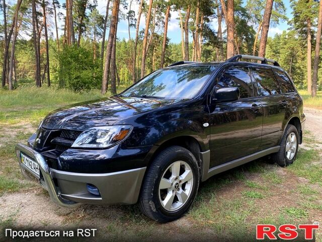 Черный Мицубиси Аутлендер, объемом двигателя 2 л и пробегом 195 тыс. км за 5650 $, фото 1 на Automoto.ua