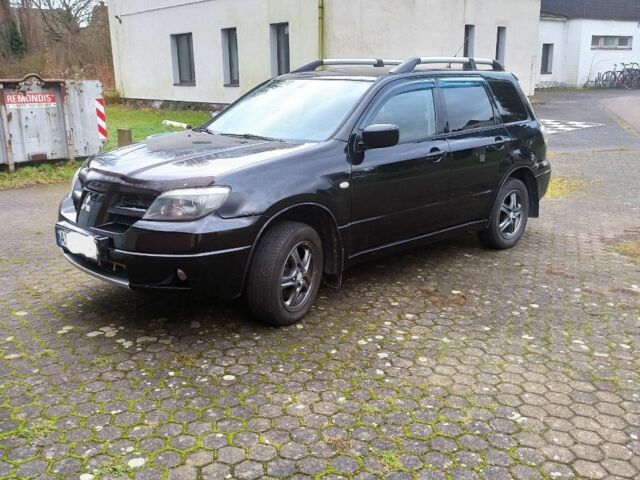 Черный Мицубиси Аутлендер, объемом двигателя 2.4 л и пробегом 269 тыс. км за 5252 $, фото 1 на Automoto.ua