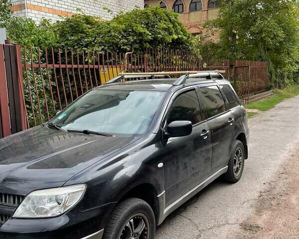 Чорний Міцубісі Аутлендер, об'ємом двигуна 2 л та пробігом 310 тис. км за 6500 $, фото 1 на Automoto.ua