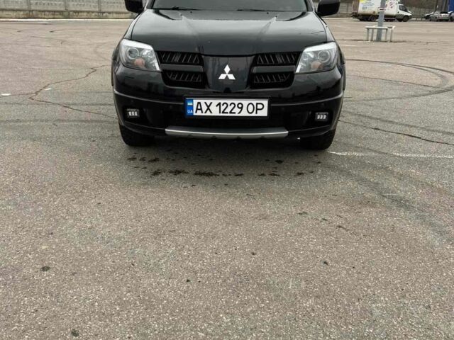 Черный Мицубиси Аутлендер, объемом двигателя 2.4 л и пробегом 190 тыс. км за 6800 $, фото 1 на Automoto.ua