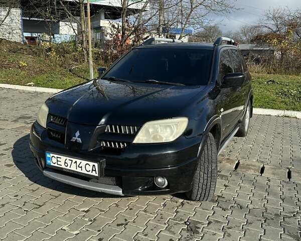 Черный Мицубиси Аутлендер, объемом двигателя 2.4 л и пробегом 307 тыс. км за 5600 $, фото 1 на Automoto.ua