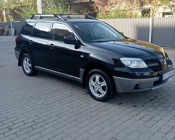 Черный Мицубиси Аутлендер, объемом двигателя 2 л и пробегом 297 тыс. км за 4550 $, фото 1 на Automoto.ua