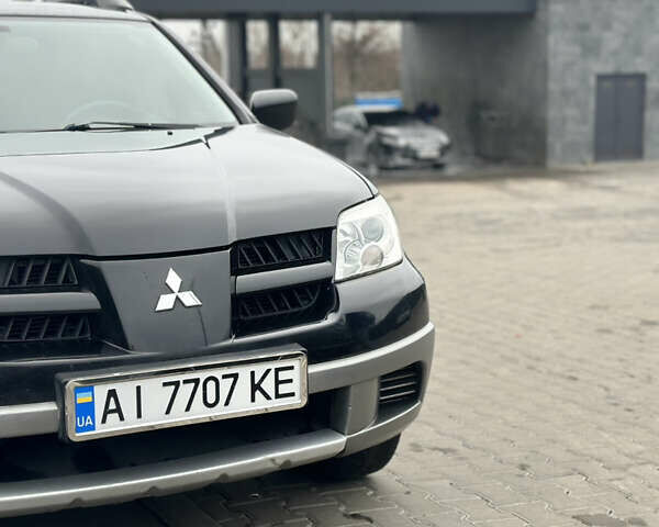 Чорний Міцубісі Аутлендер, об'ємом двигуна 2 л та пробігом 297 тис. км за 6200 $, фото 1 на Automoto.ua