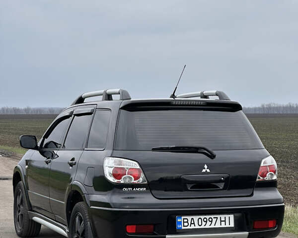 Черный Мицубиси Аутлендер, объемом двигателя 2 л и пробегом 230 тыс. км за 6300 $, фото 1 на Automoto.ua