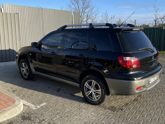 Черный Мицубиси Аутлендер, объемом двигателя 2 л и пробегом 297 тыс. км за 6500 $, фото 1 на Automoto.ua