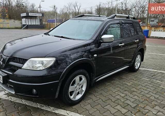 Черный Мицубиси Аутлендер, объемом двигателя 2.4 л и пробегом 167 тыс. км за 6150 $, фото 1 на Automoto.ua