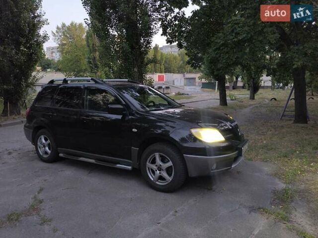 Черный Мицубиси Аутлендер, объемом двигателя 2 л и пробегом 370 тыс. км за 7000 $, фото 1 на Automoto.ua