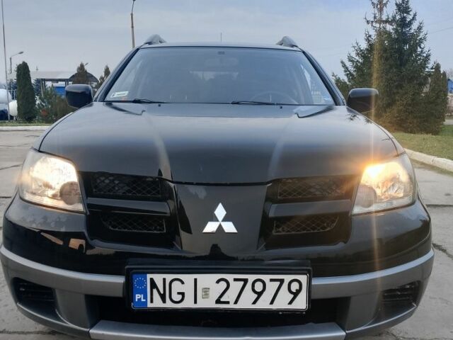 Черный Мицубиси Аутлендер, объемом двигателя 2 л и пробегом 169 тыс. км за 3500 $, фото 1 на Automoto.ua