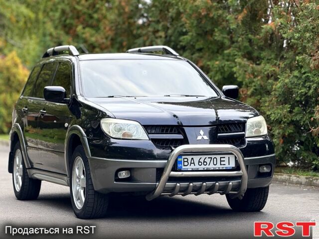 Черный Мицубиси Аутлендер, объемом двигателя 2.4 л и пробегом 263 тыс. км за 5999 $, фото 1 на Automoto.ua