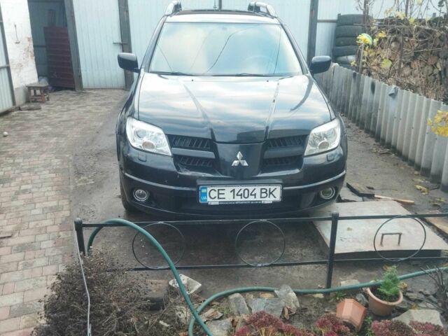 Черный Мицубиси Аутлендер, объемом двигателя 2.4 л и пробегом 280 тыс. км за 5455 $, фото 1 на Automoto.ua