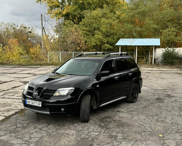 Черный Мицубиси Аутлендер, объемом двигателя 2 л и пробегом 190 тыс. км за 5700 $, фото 1 на Automoto.ua