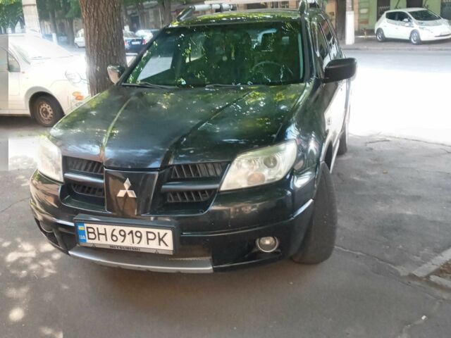 Черный Мицубиси Аутлендер, объемом двигателя 2.4 л и пробегом 248 тыс. км за 7000 $, фото 1 на Automoto.ua