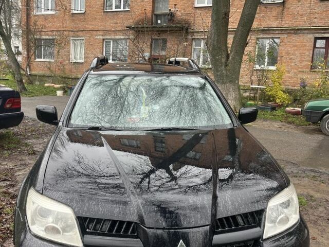 Черный Мицубиси Аутлендер, объемом двигателя 2 л и пробегом 430 тыс. км за 4300 $, фото 1 на Automoto.ua