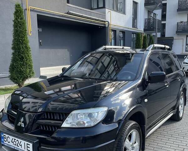 Черный Мицубиси Аутлендер, объемом двигателя 2.38 л и пробегом 310 тыс. км за 7500 $, фото 1 на Automoto.ua
