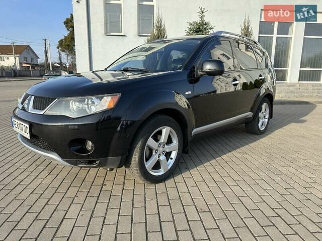 Черный Мицубиси Аутлендер, объемом двигателя 2.4 л и пробегом 234 тыс. км за 7400 $, фото 1 на Automoto.ua