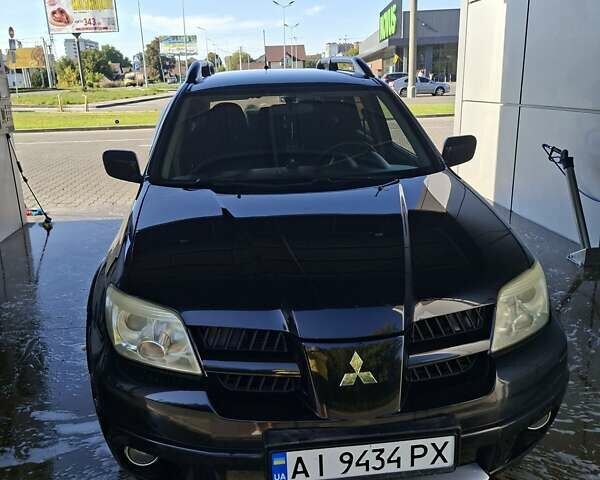 Черный Мицубиси Аутлендер, объемом двигателя 2.4 л и пробегом 270 тыс. км за 6900 $, фото 1 на Automoto.ua