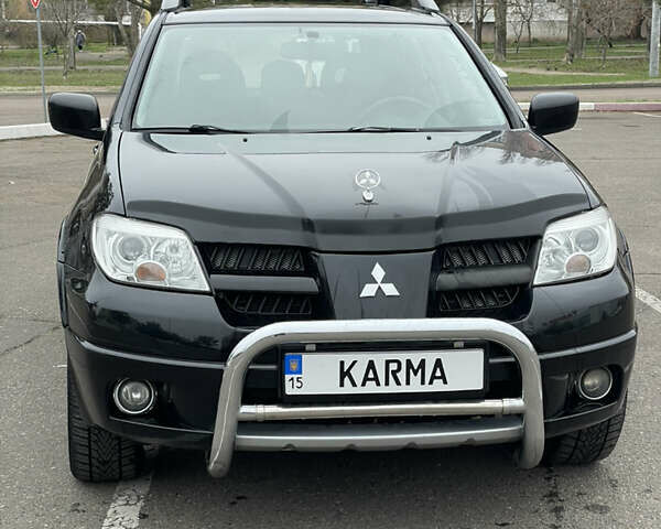 Чорний Міцубісі Аутлендер, об'ємом двигуна 2.38 л та пробігом 198 тис. км за 7100 $, фото 1 на Automoto.ua