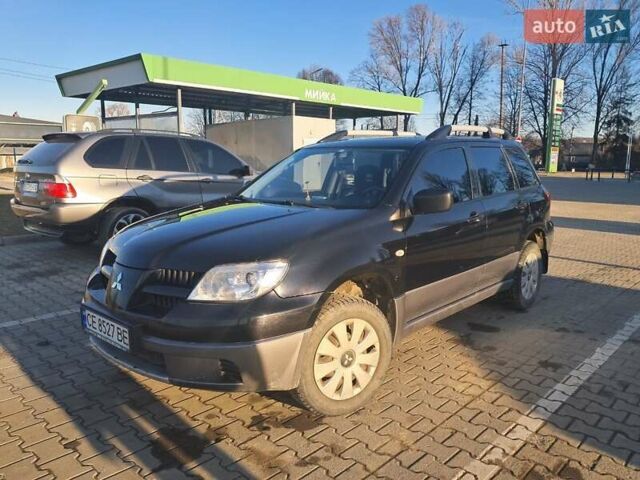 Черный Мицубиси Аутлендер, объемом двигателя 2 л и пробегом 190 тыс. км за 8000 $, фото 1 на Automoto.ua