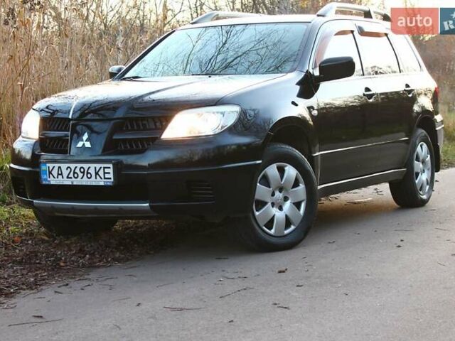 Черный Мицубиси Аутлендер, объемом двигателя 2 л и пробегом 190 тыс. км за 6900 $, фото 1 на Automoto.ua