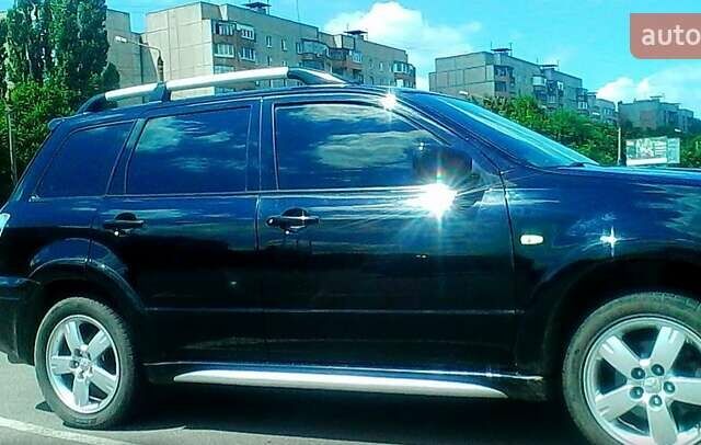 Черный Мицубиси Аутлендер, объемом двигателя 2.4 л и пробегом 150 тыс. км за 6300 $, фото 1 на Automoto.ua