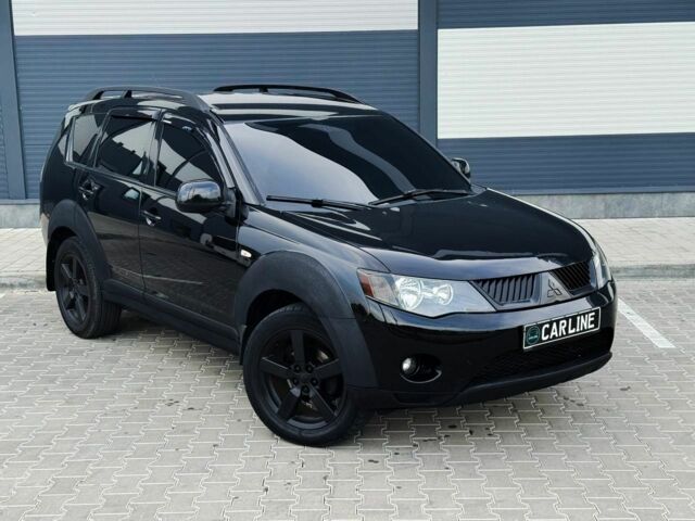 Черный Мицубиси Аутлендер, объемом двигателя 2.4 л и пробегом 199 тыс. км за 6470 $, фото 1 на Automoto.ua