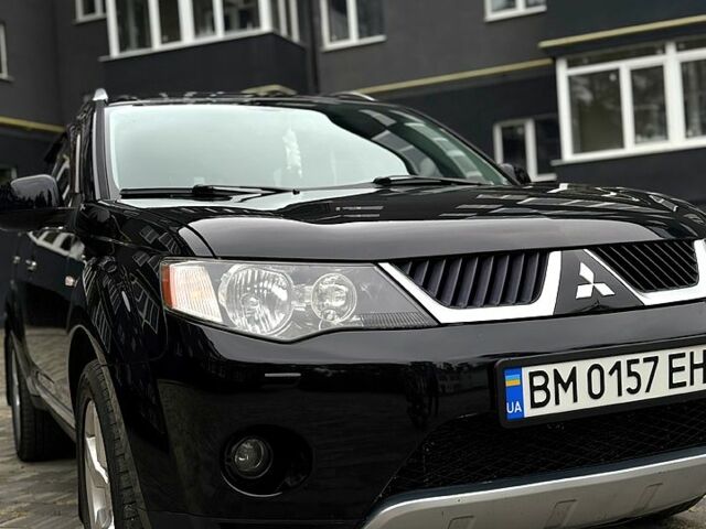 Черный Мицубиси Аутлендер, объемом двигателя 2.4 л и пробегом 210 тыс. км за 9900 $, фото 1 на Automoto.ua