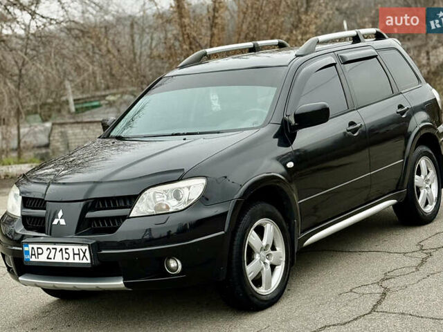 Черный Мицубиси Аутлендер, объемом двигателя 2.4 л и пробегом 245 тыс. км за 6500 $, фото 1 на Automoto.ua
