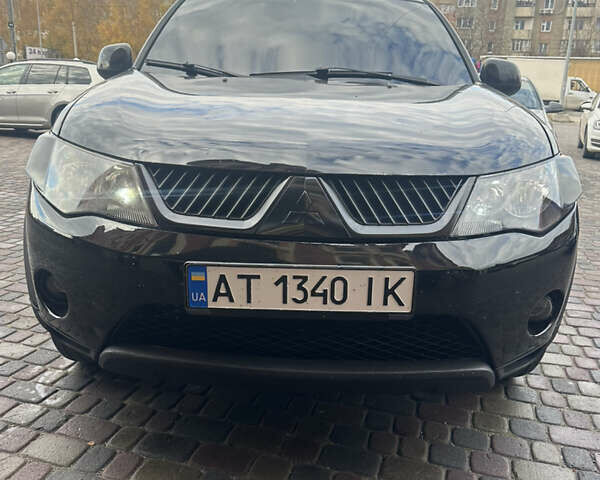 Черный Мицубиси Аутлендер, объемом двигателя 2.4 л и пробегом 199 тыс. км за 8777 $, фото 1 на Automoto.ua