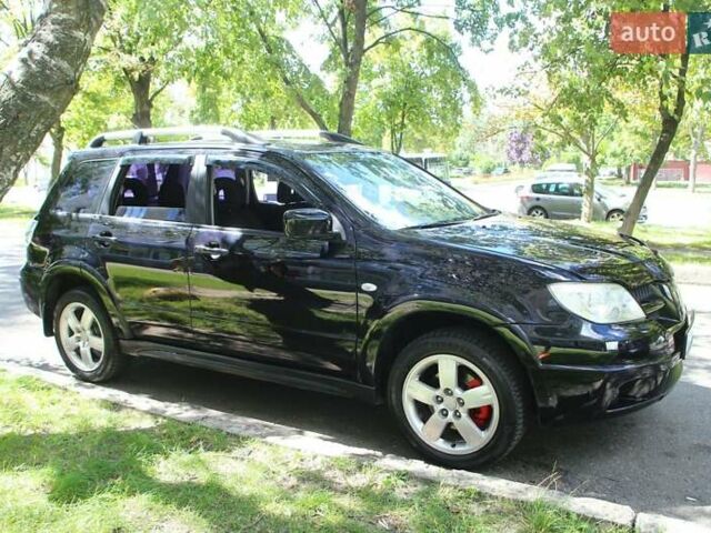 Черный Мицубиси Аутлендер, объемом двигателя 2.38 л и пробегом 333 тыс. км за 7999 $, фото 1 на Automoto.ua