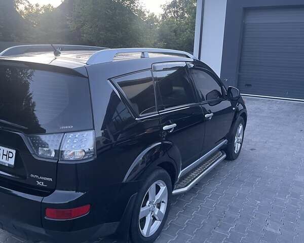 Черный Мицубиси Аутлендер, объемом двигателя 2.4 л и пробегом 290 тыс. км за 9500 $, фото 1 на Automoto.ua