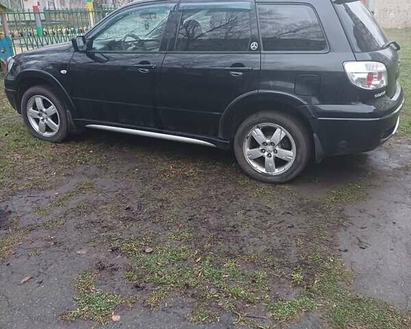 Черный Мицубиси Аутлендер, объемом двигателя 2.4 л и пробегом 270 тыс. км за 6700 $, фото 1 на Automoto.ua
