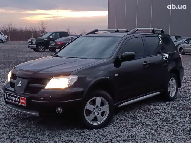 Черный Мицубиси Аутлендер, объемом двигателя 2 л и пробегом 271 тыс. км за 6940 $, фото 1 на Automoto.ua