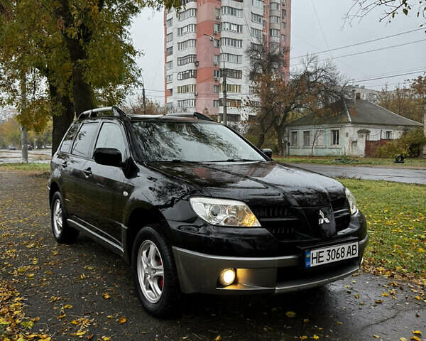 Черный Мицубиси Аутлендер, объемом двигателя 2 л и пробегом 254 тыс. км за 7300 $, фото 1 на Automoto.ua