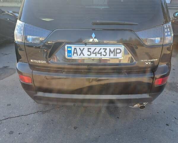 Черный Мицубиси Аутлендер, объемом двигателя 2.36 л и пробегом 245 тыс. км за 9200 $, фото 1 на Automoto.ua