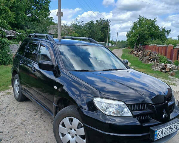 Чорний Міцубісі Аутлендер, об'ємом двигуна 2 л та пробігом 161 тис. км за 7499 $, фото 1 на Automoto.ua