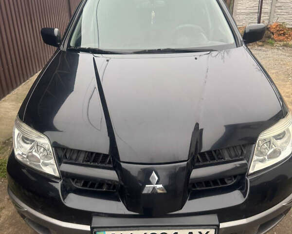 Черный Мицубиси Аутлендер, объемом двигателя 2 л и пробегом 130 тыс. км за 7500 $, фото 1 на Automoto.ua