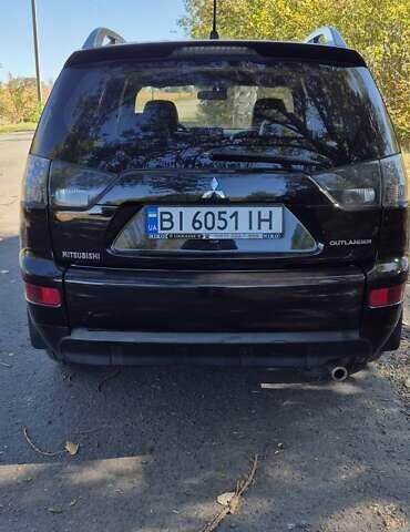 Черный Мицубиси Аутлендер, объемом двигателя 2.4 л и пробегом 178 тыс. км за 9150 $, фото 1 на Automoto.ua