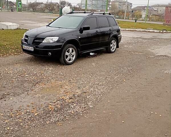 Черный Мицубиси Аутлендер, объемом двигателя 2 л и пробегом 209 тыс. км за 5700 $, фото 1 на Automoto.ua