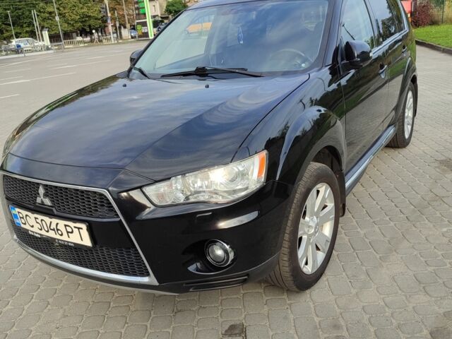 Черный Мицубиси Аутлендер, объемом двигателя 2 л и пробегом 104 тыс. км за 9900 $, фото 1 на Automoto.ua
