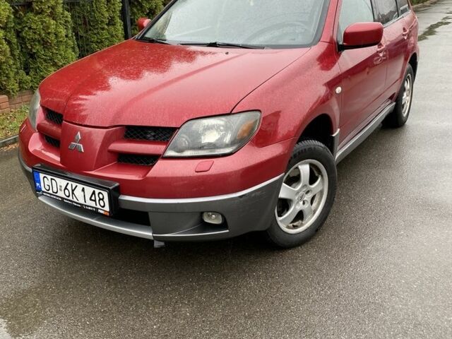 Красный Мицубиси Аутлендер, объемом двигателя 2.4 л и пробегом 293 тыс. км за 3595 $, фото 1 на Automoto.ua