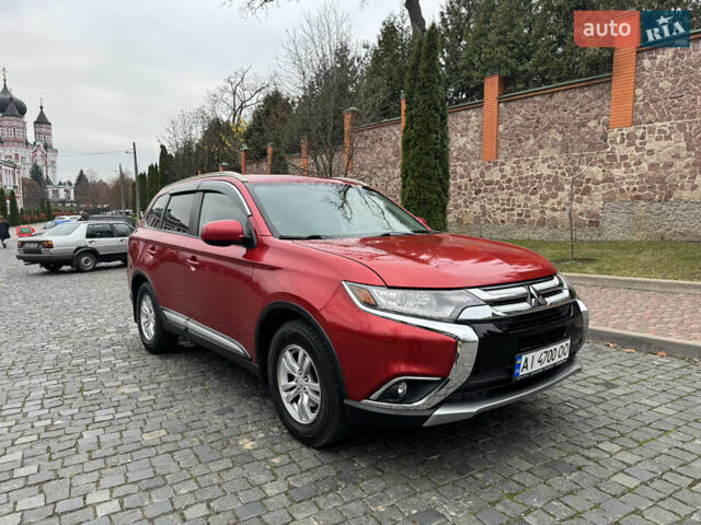 Красный Мицубиси Аутлендер, объемом двигателя 2.4 л и пробегом 225 тыс. км за 11900 $, фото 1 на Automoto.ua