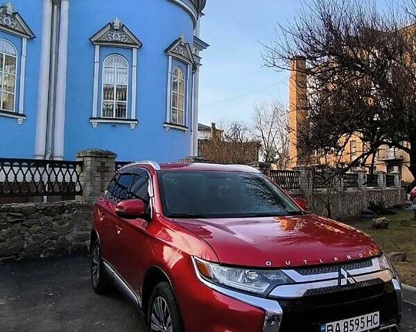 Красный Мицубиси Аутлендер, объемом двигателя 2.4 л и пробегом 125 тыс. км за 17400 $, фото 1 на Automoto.ua